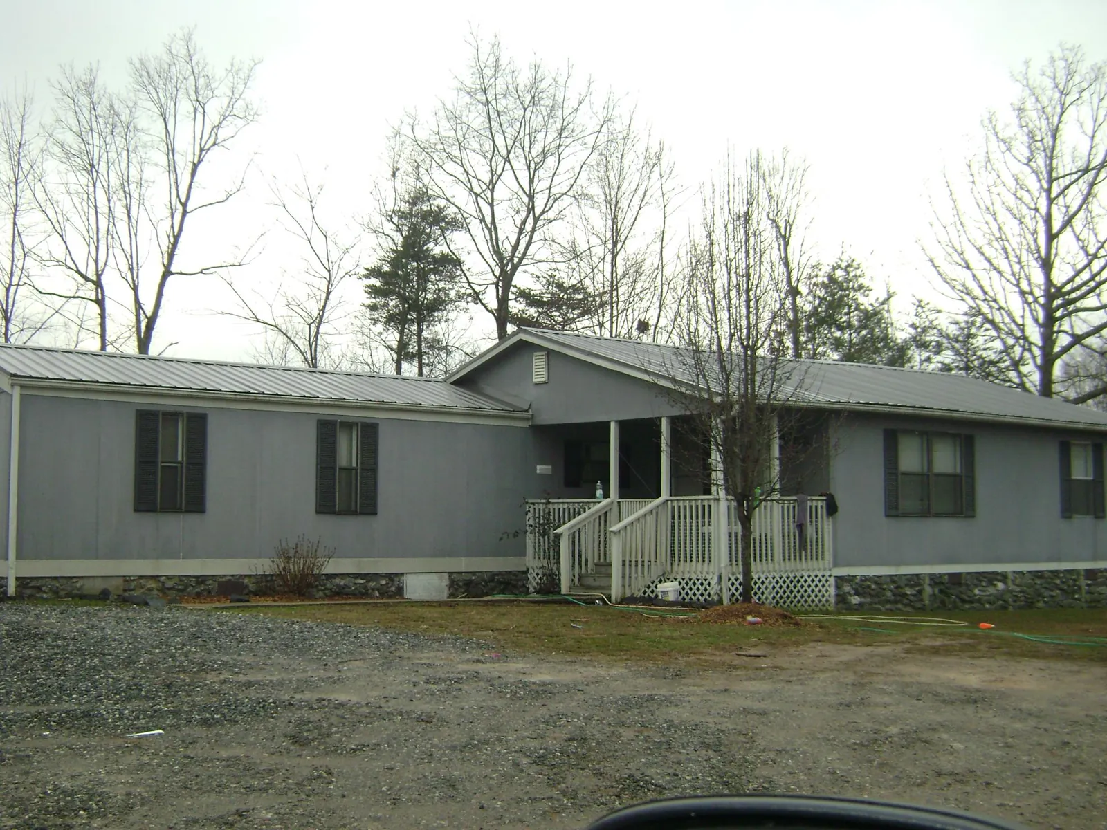 Metal roof over a manufactured home with a covered front porch in Elizabeth City